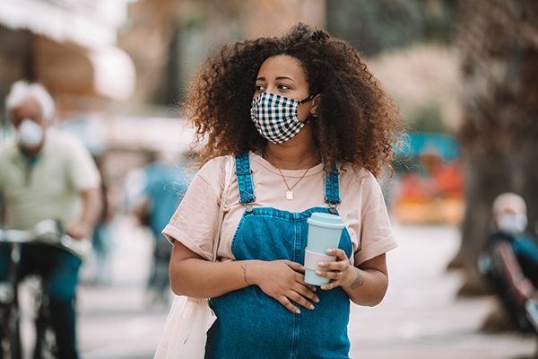 Pregnant woman with mask on in public