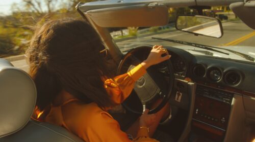 Woman driving a convertible car